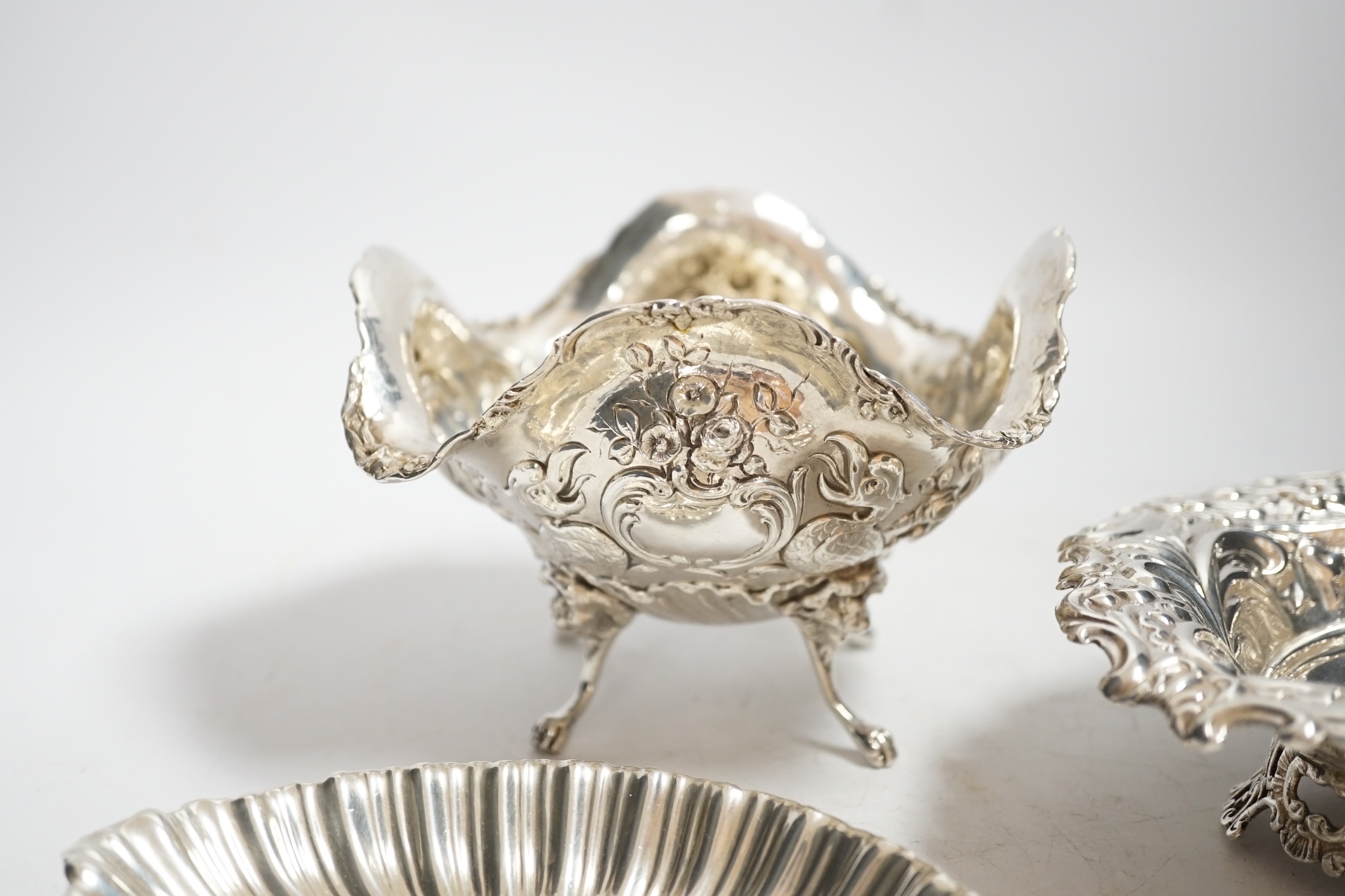 A late Victorian repousse silver heart shaped dish, I.S. Greenburg & Co, Birmingham, 1894, 14.3cm, a small silver dish and Hanau white metal bowl, 12.1oz.